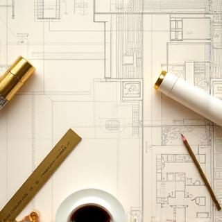 Interior designers reviewing hotel floor plans